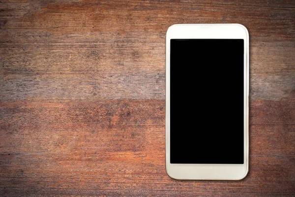 Weißes Smartphone auf Holztisch — Stockfoto