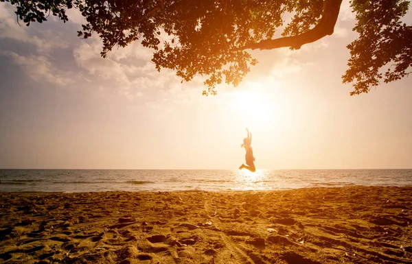 One asian girl jumping on the beach at the sunset time — Stock Photo, Image