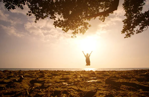 Jedna dziewczyna azjatyckich, skoki na plaży o zachodzie słońca — Zdjęcie stockowe