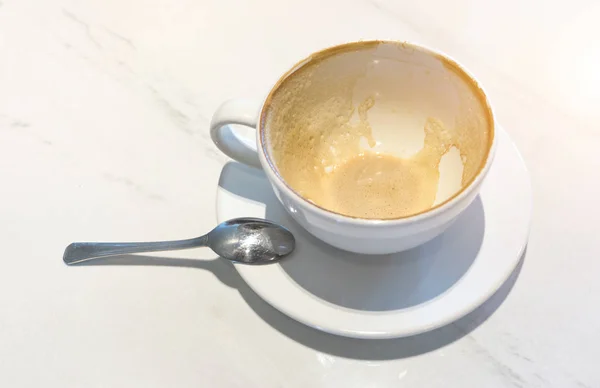 Café vide en tasse et table en marbre blanc après boisson . — Photo