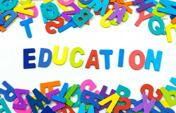 The letters made of plywood the words education are on a white b — Stock Photo, Image