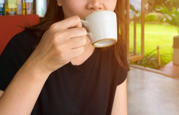 Female hand holding a cup of coffee Stock Photo