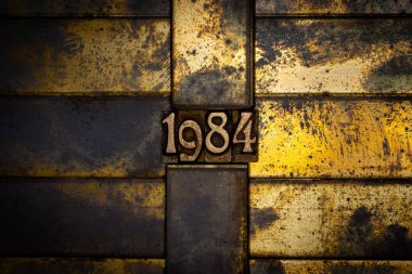 Photo of real authentic typeset numbers forming 1984on vintage textured grunge copper background clipart
