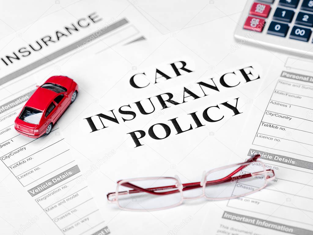 Car Insurance Policy. Document, Car, Glasses and Calculator on Table