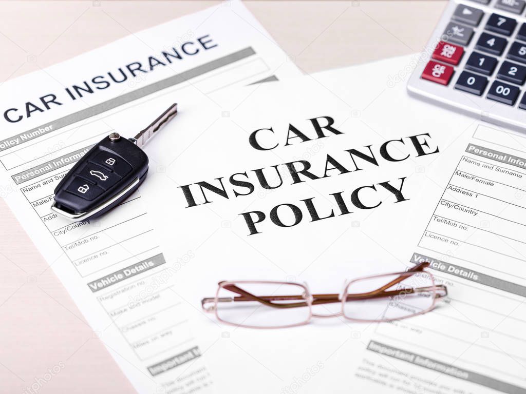 Car Insurance Policy. Document, Key, Glasses and Calculator on Table