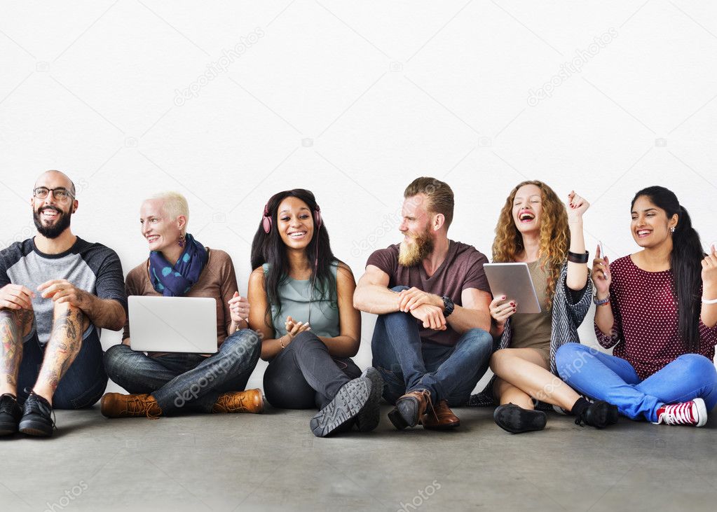 people with devices sits on floor