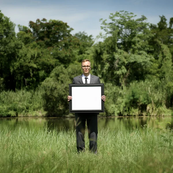 Hombre de negocios celebración de tablero de anuncios — Foto de Stock