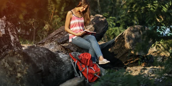 Woman writing notes in nature