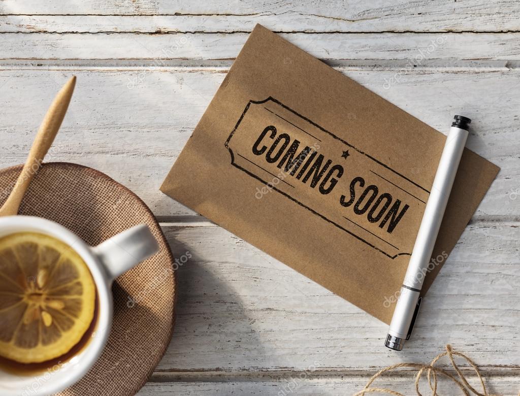 Tea cup with lemon and paper with pen, inspire Concept. Text: Coming Soon