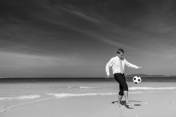 Businessman playing Football on beach — Stock Photo, Image