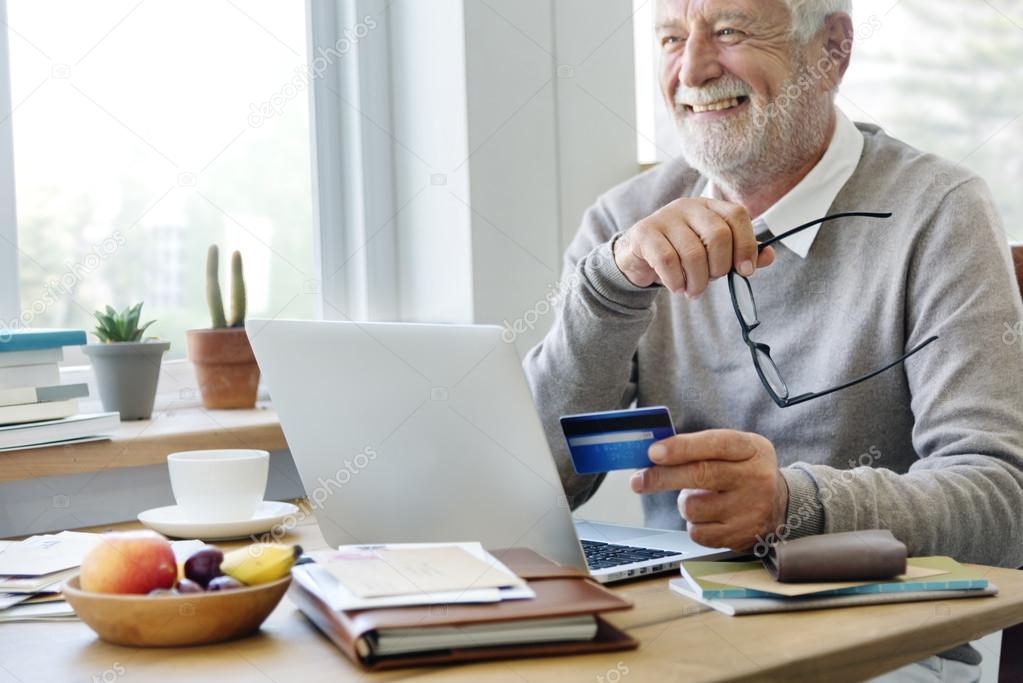 old man holding credit card