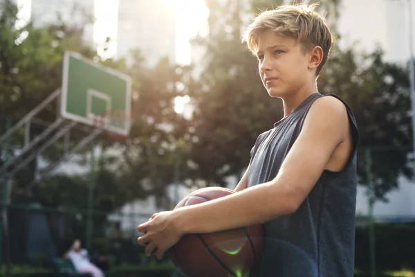 Menino segurando bola de basquete — Fotografia de Stock