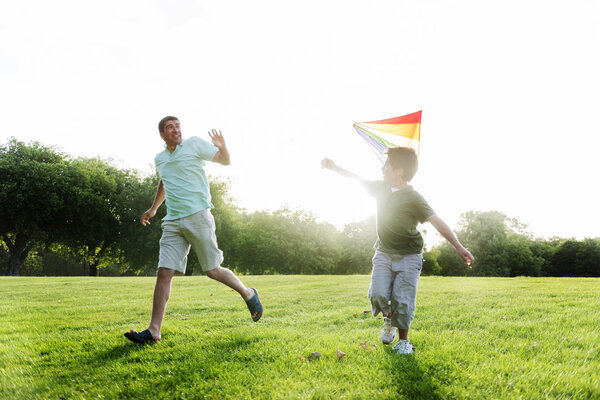 Father and son playing with kite