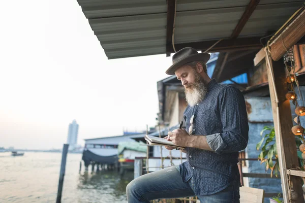 stock image handsome senior man writing notes