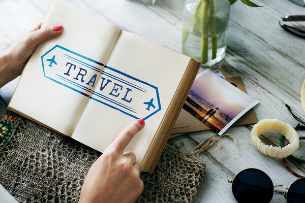 Woman using diary for notes, Creativity Concept. Text: Travel