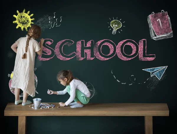 Children drawing on blackboard — Stock Photo, Image