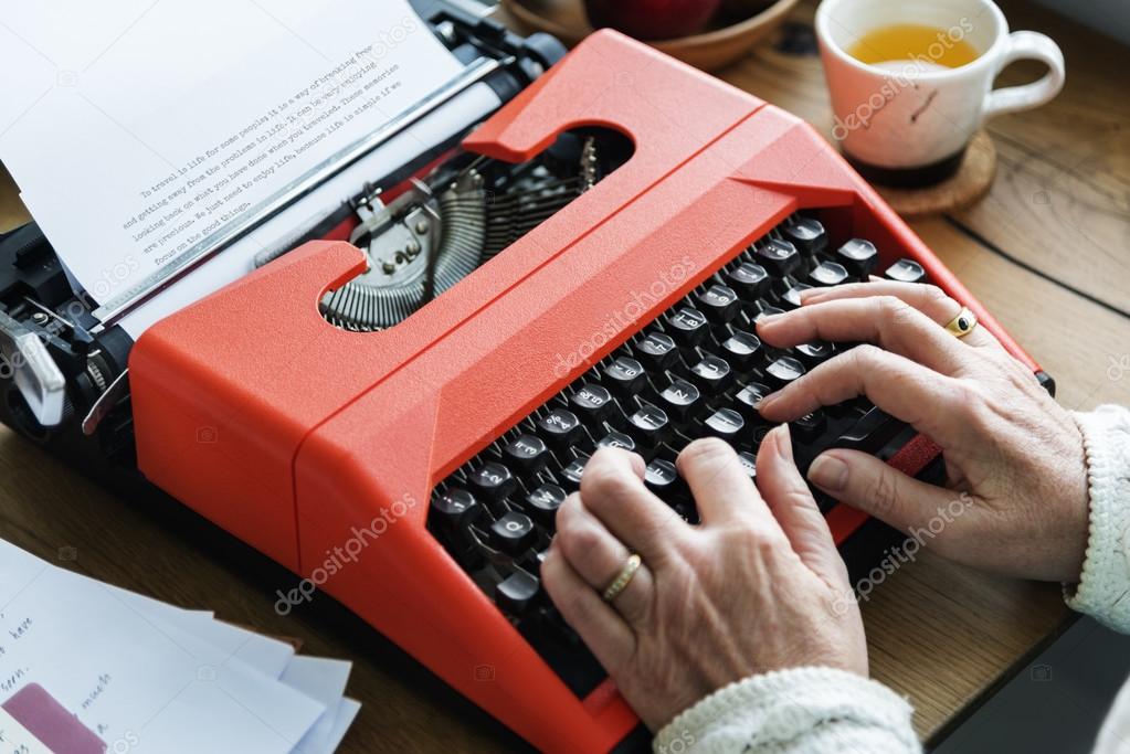 woman Typing on vintage Typewriter machine
