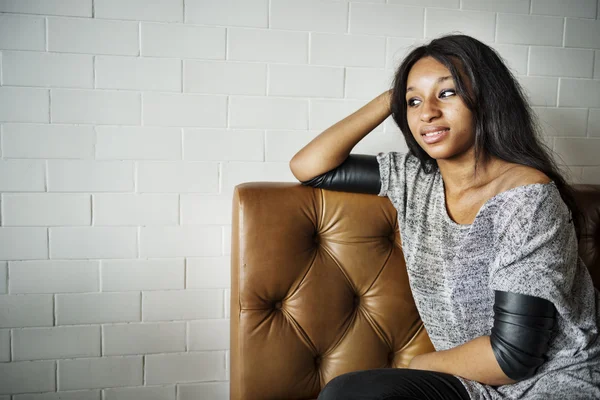 Fille assis dans le café au canapé en cuir — Photo