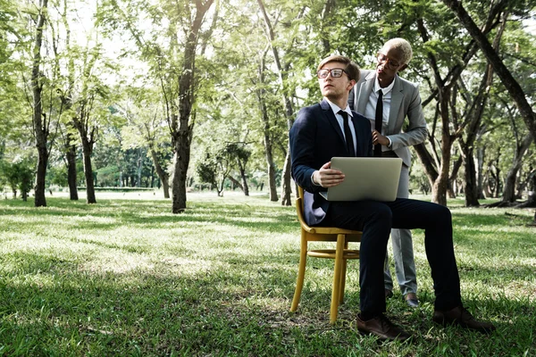 Kollegor med laptop på park — Stockfoto