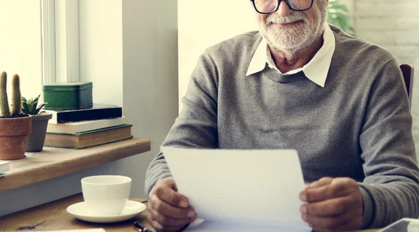 Senior Man holding paper document — Stock Photo, Image