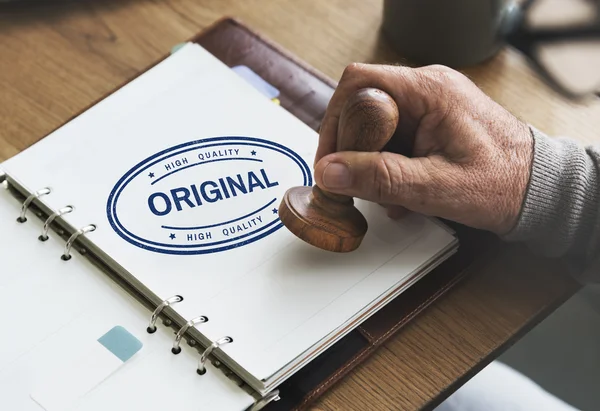 Man putting stamp on paper notebook — Stock Photo, Image