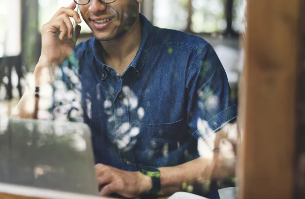 Mężczyzna rozmawia na telefonie i za pomocą laptopa — Zdjęcie stockowe