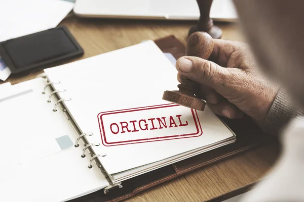 Man putting stamp on paper notebook — Stock Photo, Image