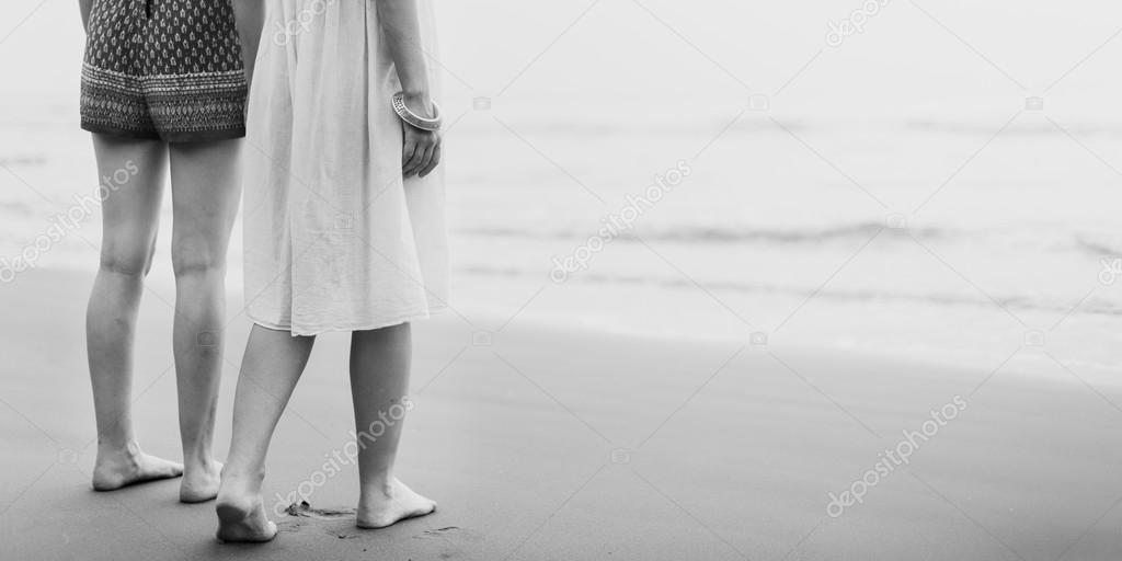 women barefoot at beach