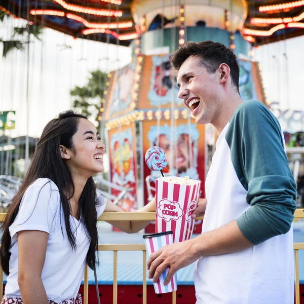 Casal rindo no parque de diversões — Fotografia de Stock