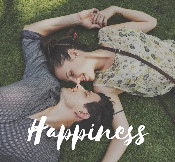 Loving couple lying on grass — Stock Photo, Image