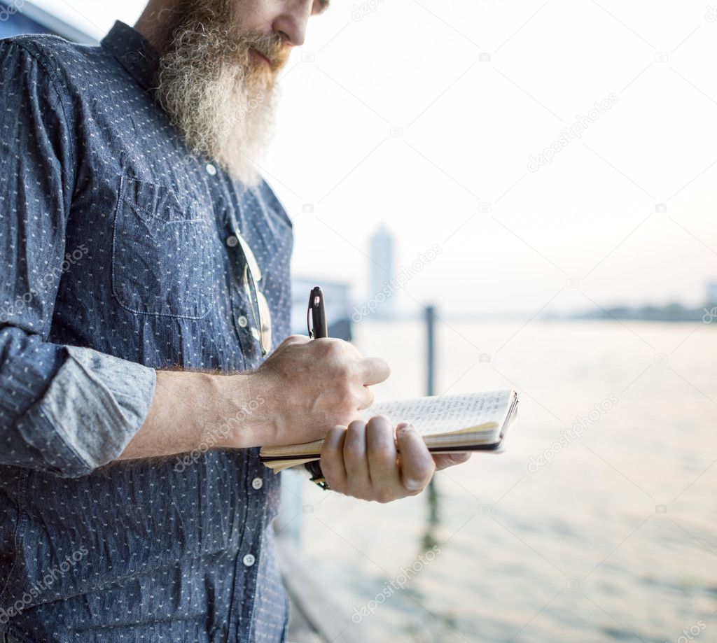 man writing notes