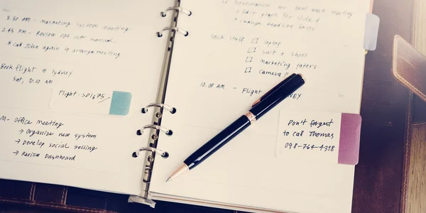 Workplace table with diary and pen — Stock Photo, Image