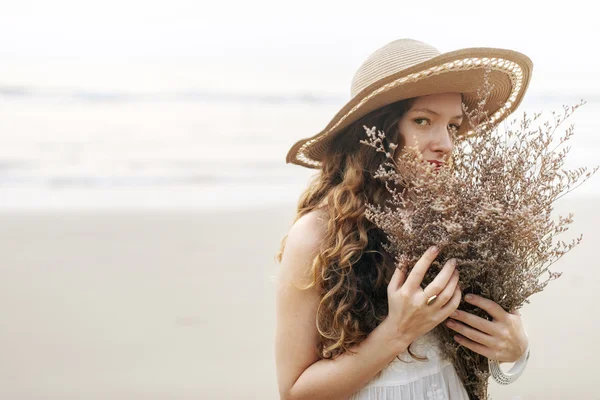 Beautiful woman with dry flowers — Stock Photo, Image