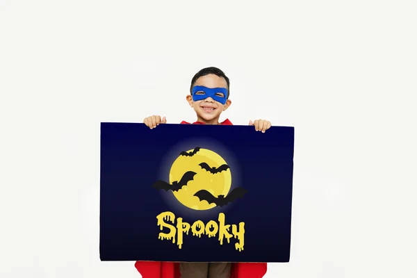 Superhero boy with cardboard in hands — Stock Photo, Image