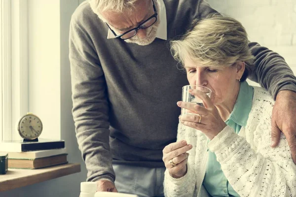 Adultos mayores tomando píldoras — Foto de Stock