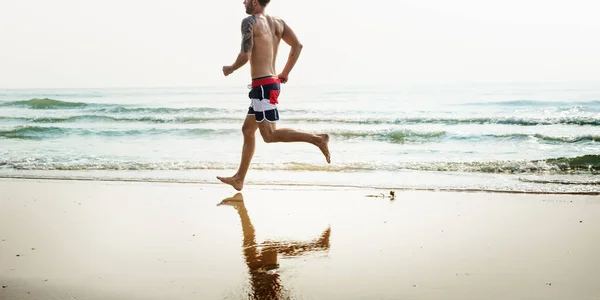 男人在海滩上奔跑 — 图库照片