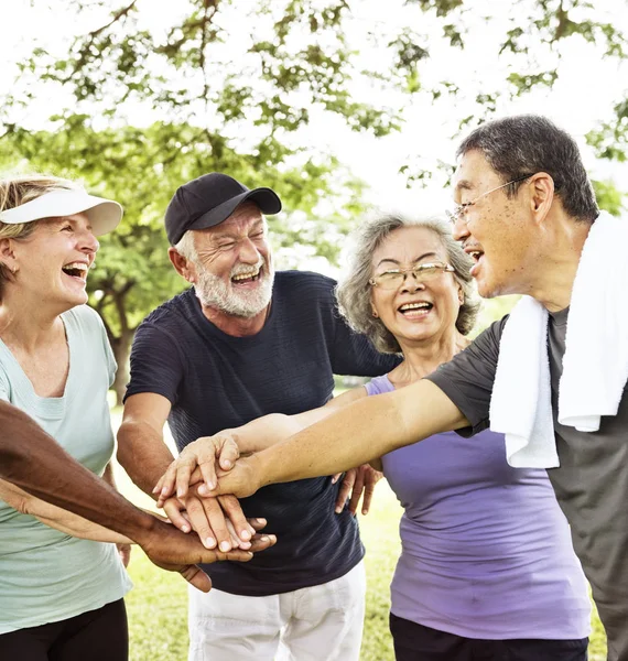 Senior friends shaking hands — Stock Photo, Image