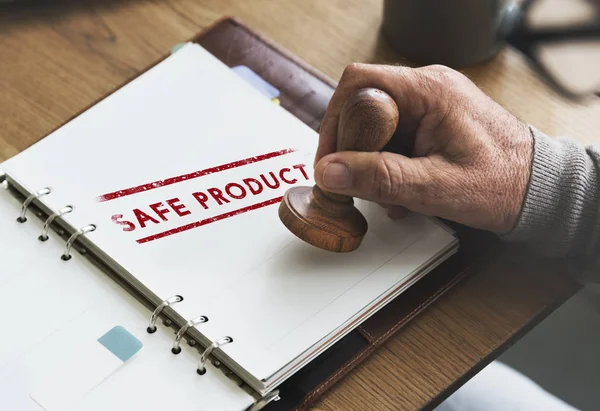 Man putting stamp on paper notebook — Stock Photo, Image