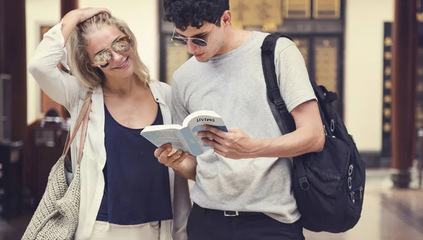 Par söker i guidebok — Stockfoto