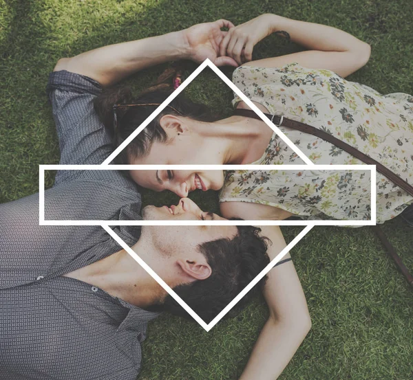 Loving couple lying on grass — Stock Photo, Image