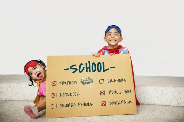 Superhéroe Niños con tabla en las manos —  Fotos de Stock