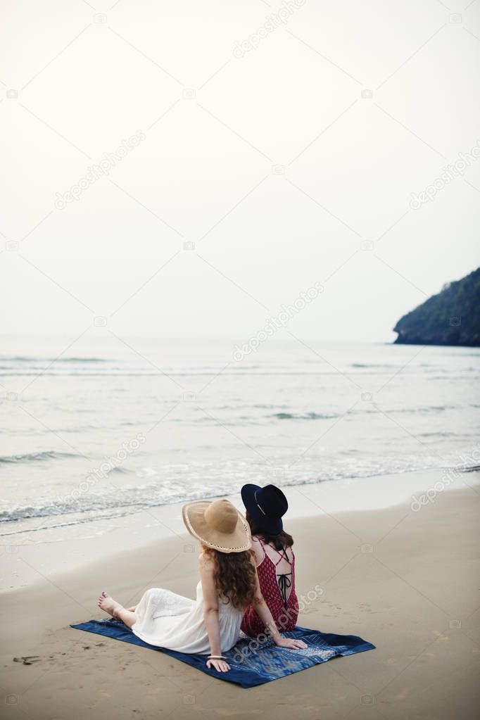 beautiful women chilling near ocean