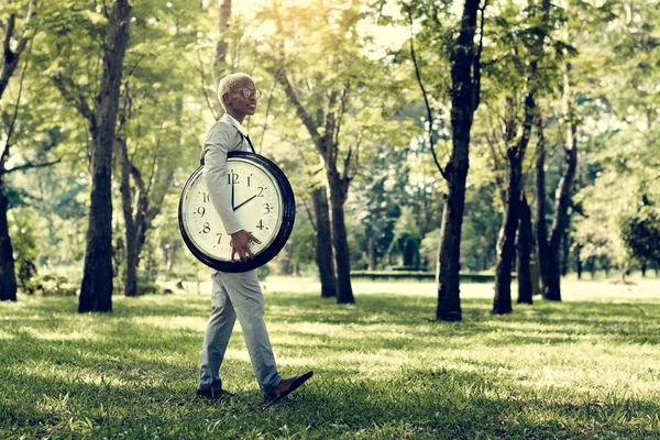 Businessman with round clock — Stock Photo, Image