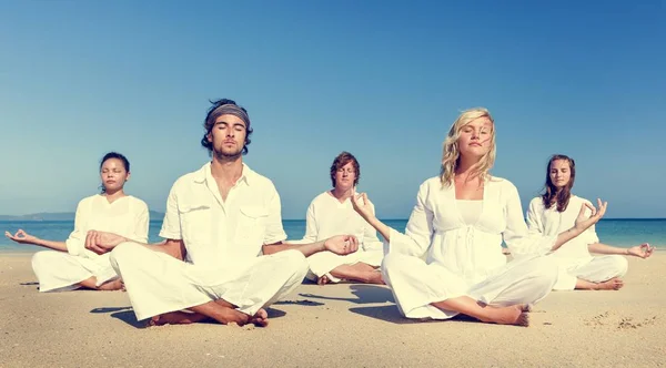 Människor som gör Yoga på stranden — Stockfoto