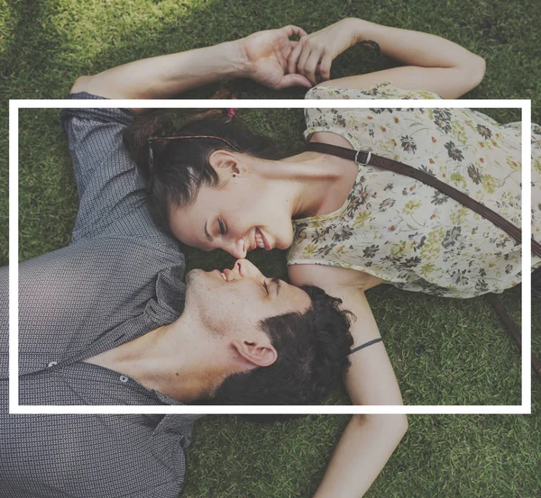 Loving couple lying on grass — Stock Photo, Image