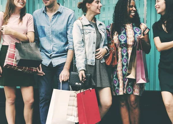 Amigos alegres sosteniendo bolsas de compras — Foto de Stock