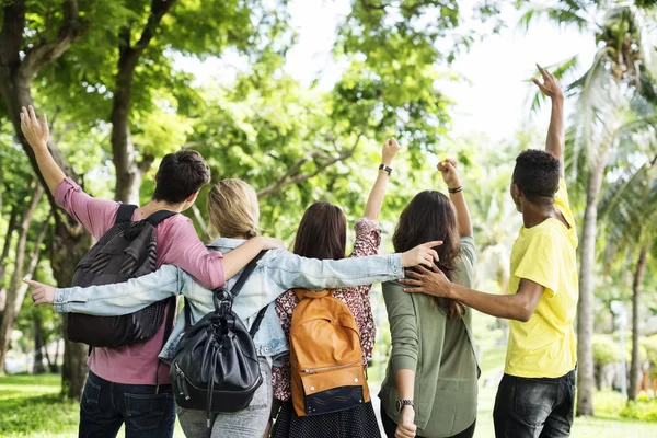 Студенты идут в университет через парк — стоковое фото