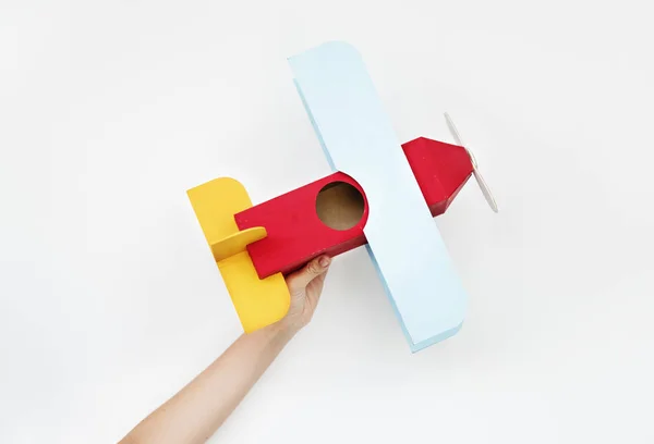 Person holding toy airplane — Stock Photo, Image