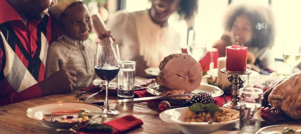 family at table with a festive dinner