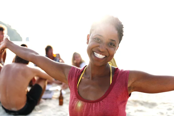 Afrikaanse vrouw die lacht op strand — Stockfoto